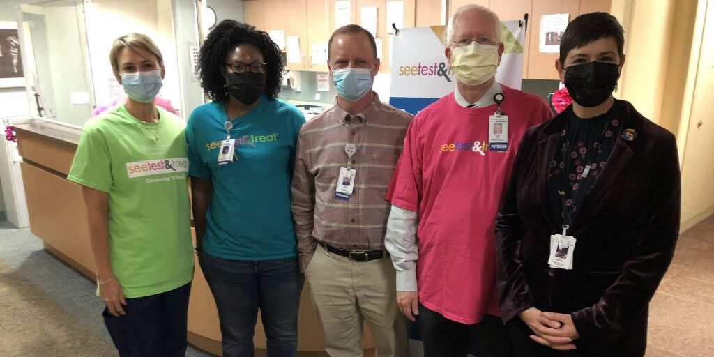 Pathologist Bradley M. Linzie (in pink) stands with other volunteers from NorthPoint's 2021 See, Test & Treat event. 
