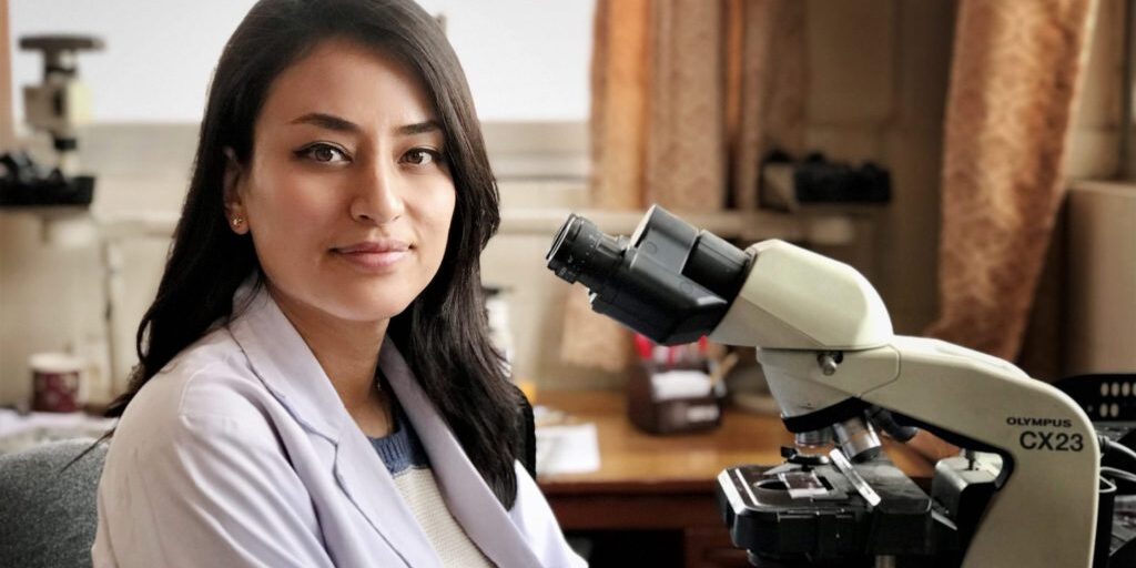 Dr. Manisha Shrestha with microscope