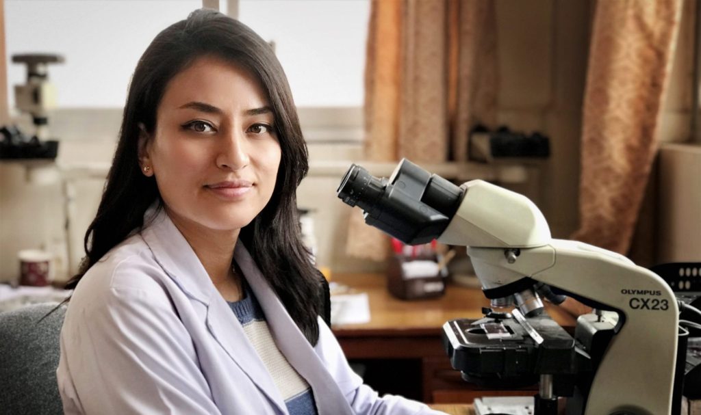 Dr. Manisha Shrestha with microscope